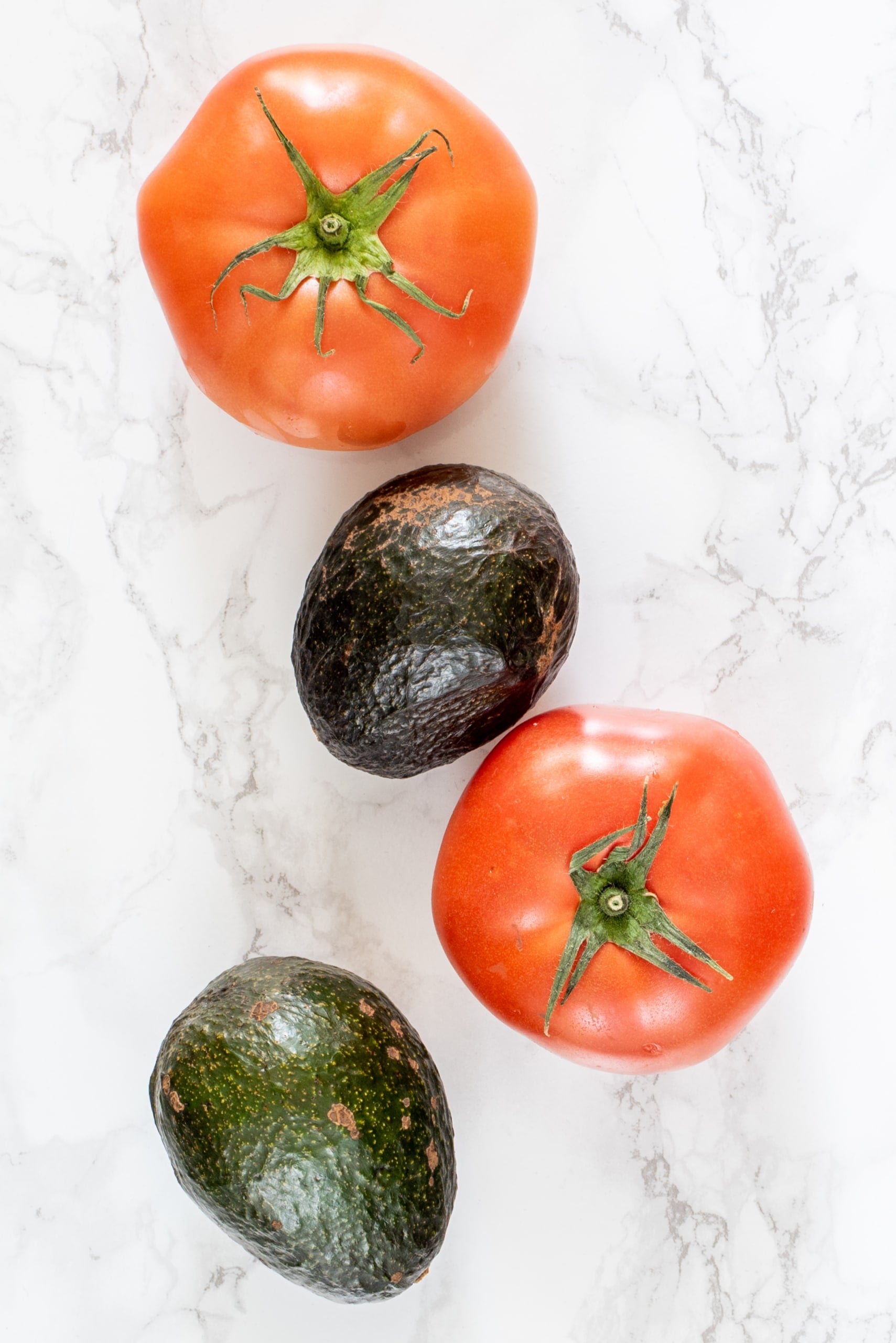 Two tomatoes and two avocados.