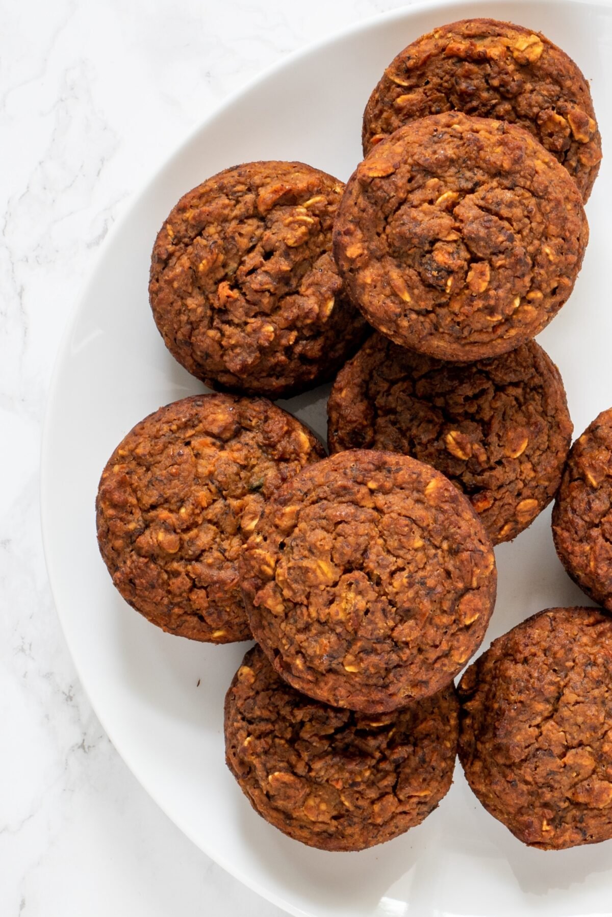 Vegan Carrot Cake Muffins on half of a white plate.