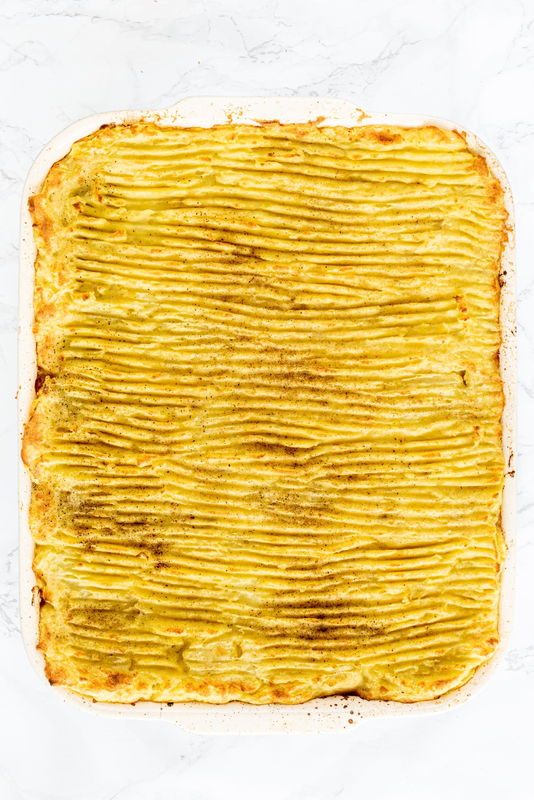 A casserole dish filled with mashed potatoes.