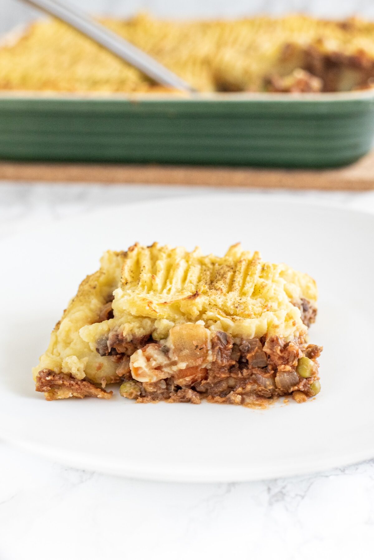 A piece of shepherd's pie on a small plate.