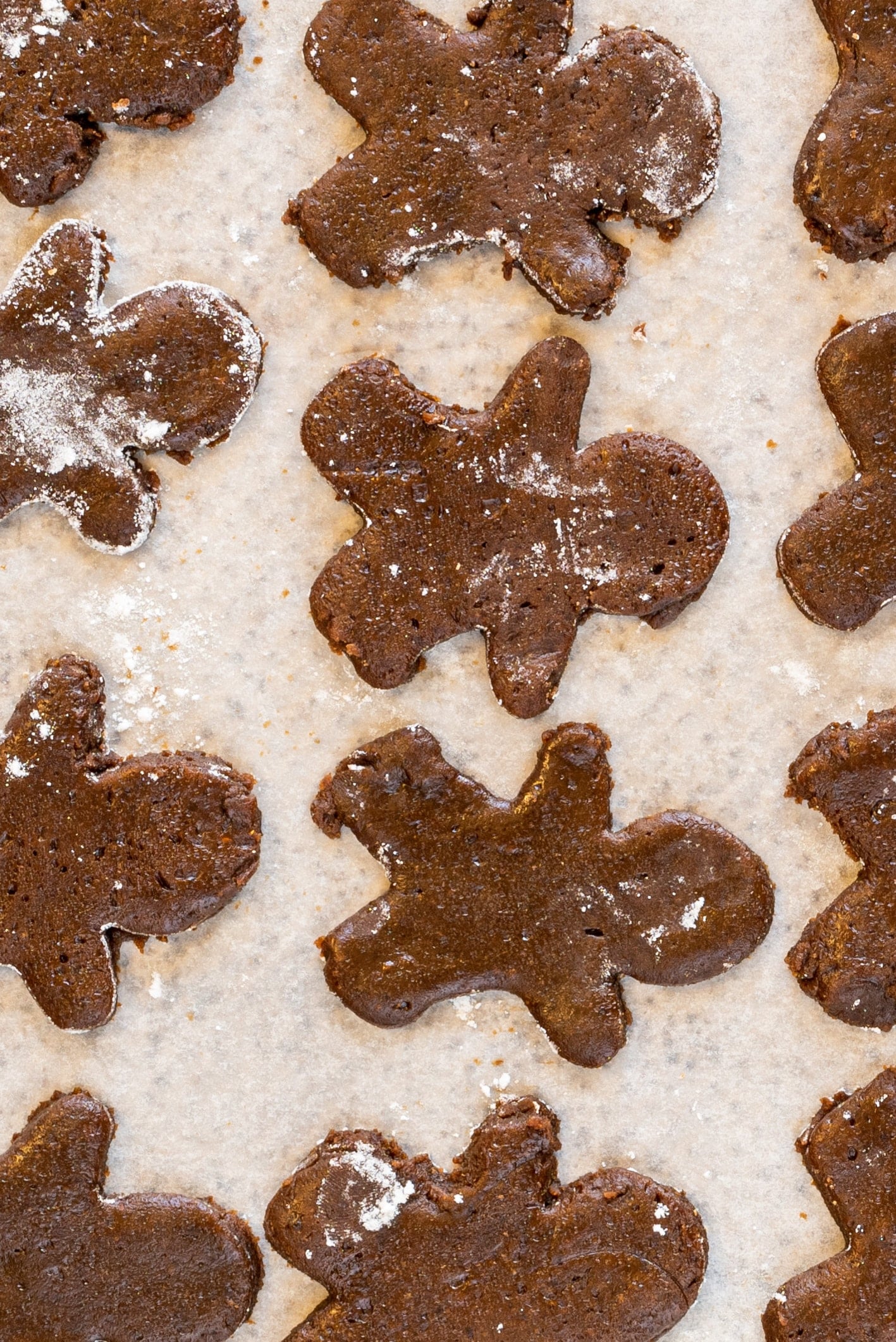 A baking sheet filled with gingerbread cookies ready to be baked.