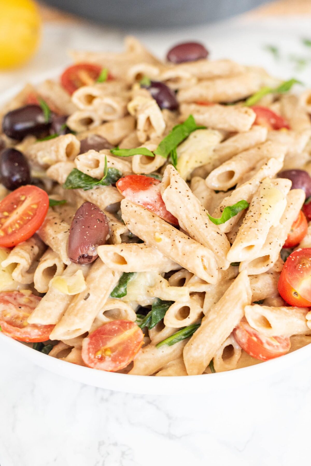 Close up of the creamy Vegan Hummus Pasta in a white serving bowl.