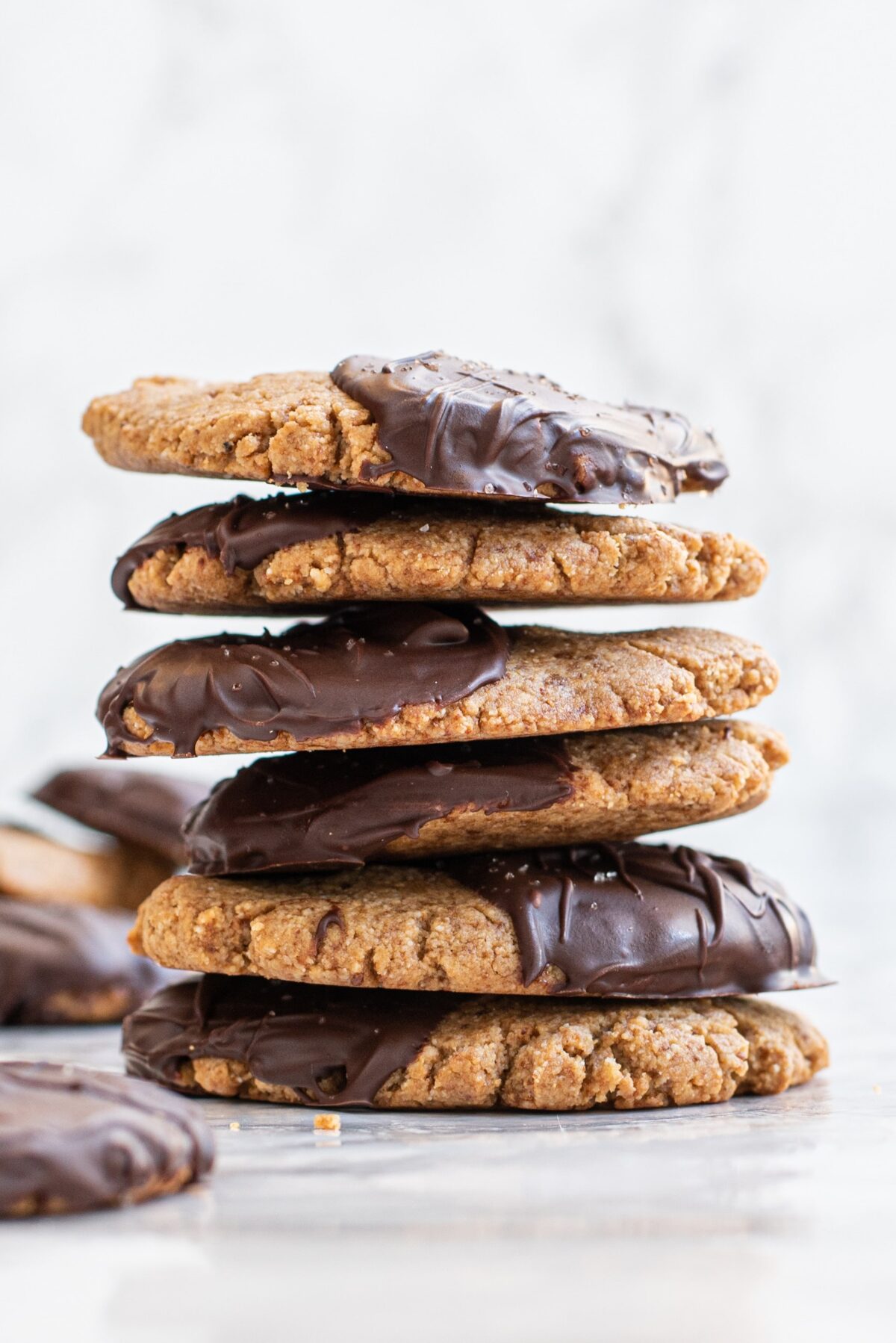 A stack of chocolate dipped peanut butter cookies.