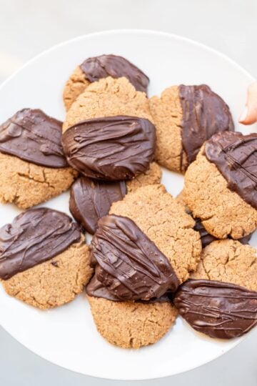 A plate of Vegan Chocolate Dipped Peanut Butter Cookies.