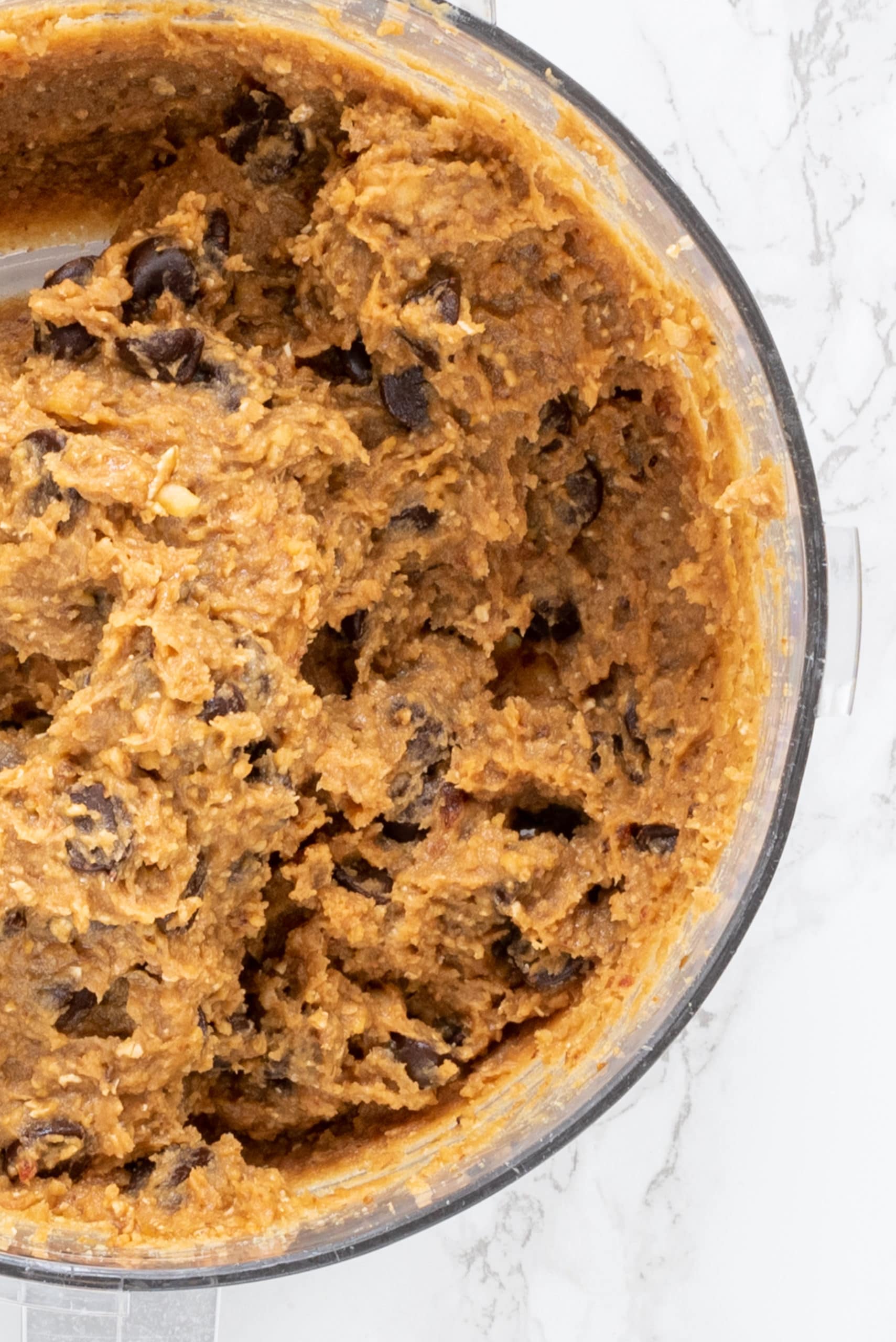 A food processor filled with chickpea cookie dough.