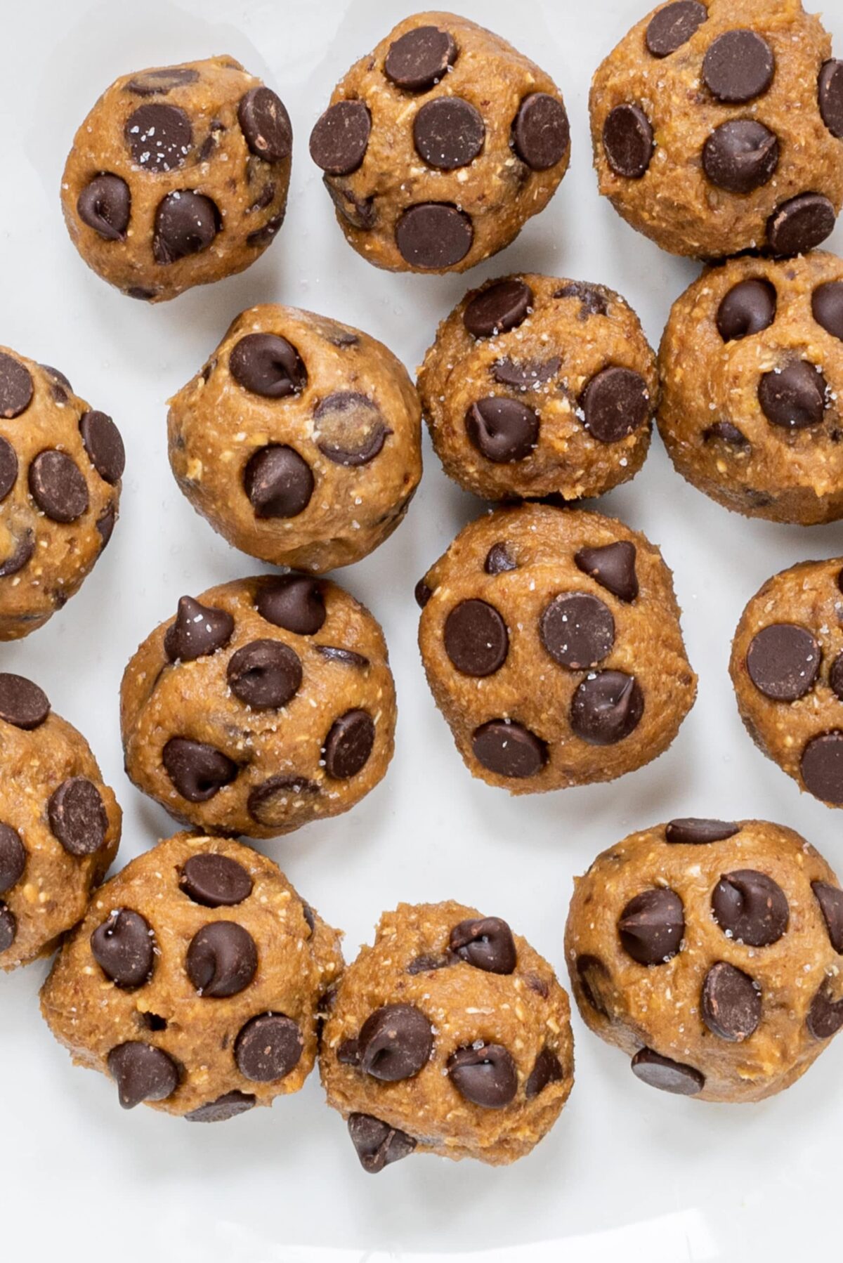 A plate of cookie dough bites rolled in chocolate chips.