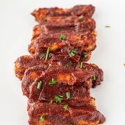 A white plate with a stack of Vegan BBQ Tempeh Ribs.