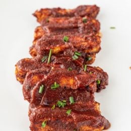 A white plate with a stack of Vegan BBQ Tempeh Ribs.