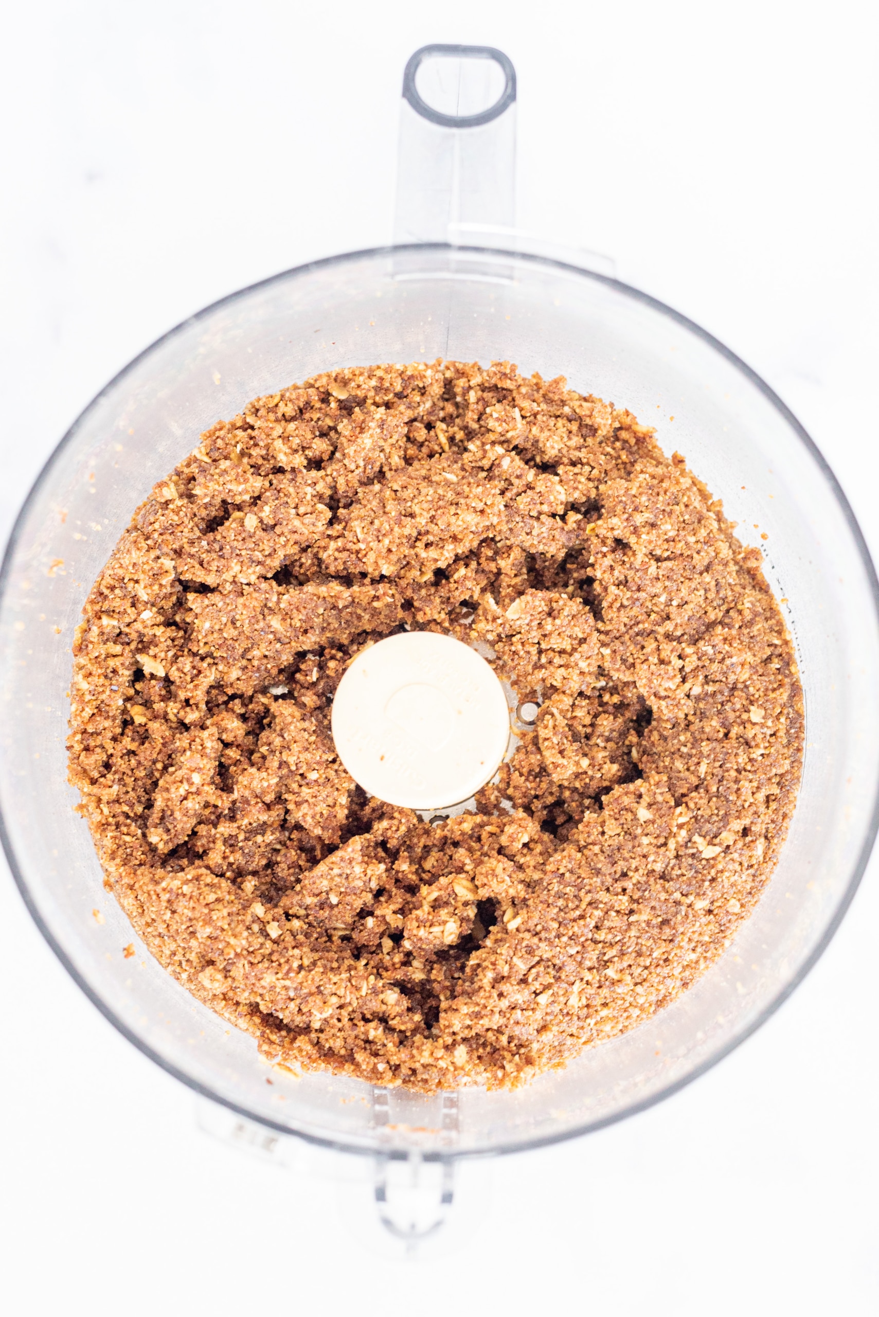 A food processor filled with cookie crumbs.