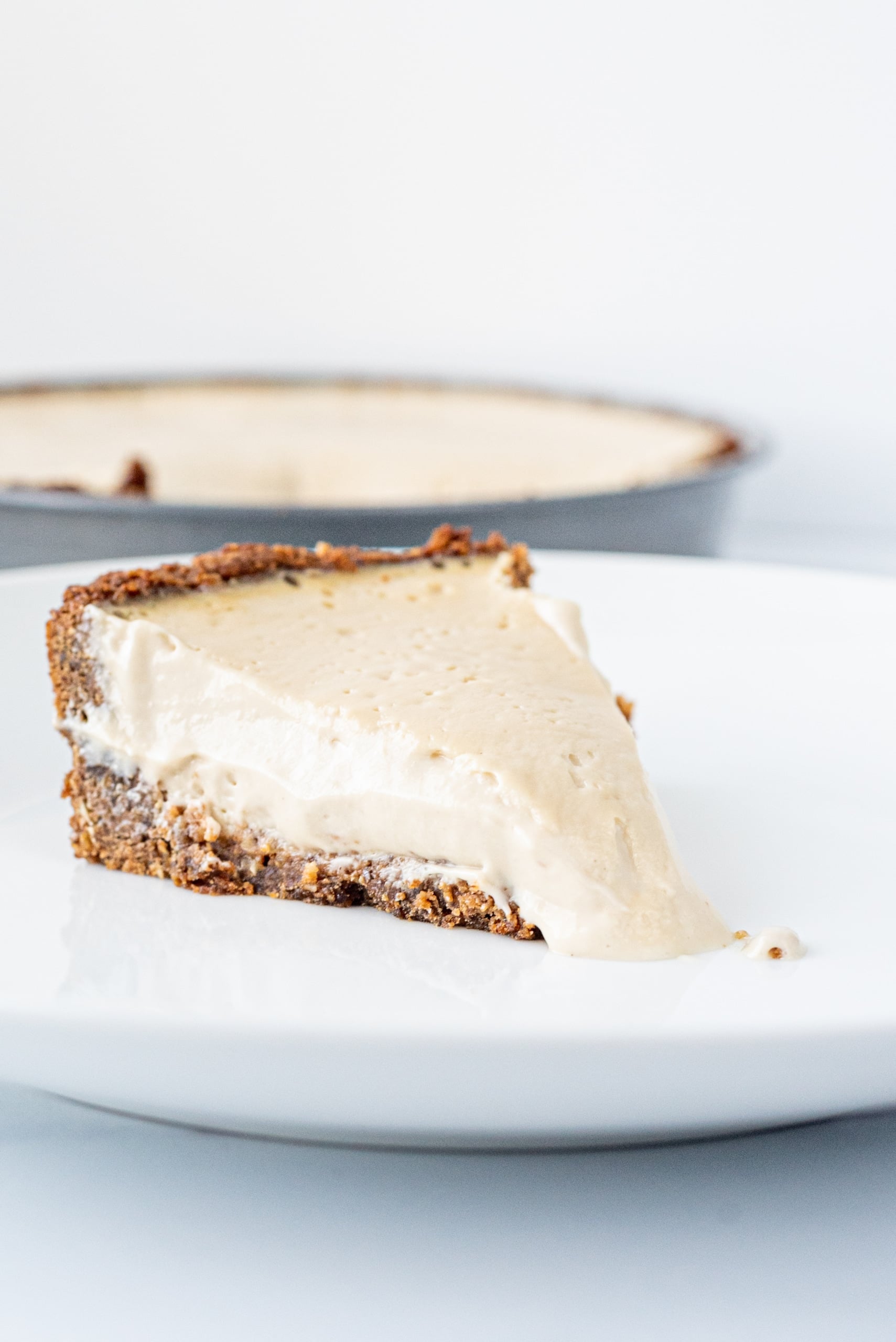 A piece of vanilla pie on a white plate.
