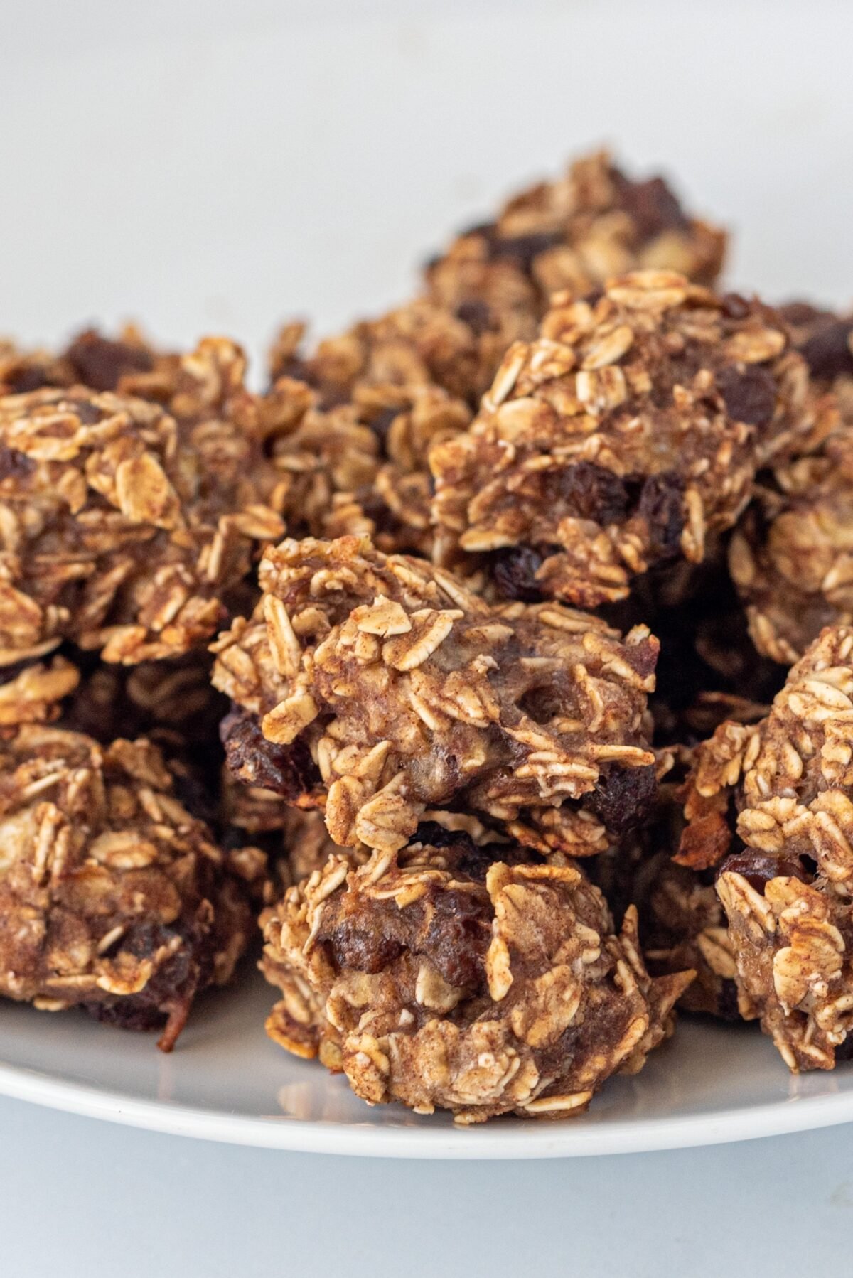 3-Ingredient Oatmeal Banana Bites stacked up in a pile on a white plate.