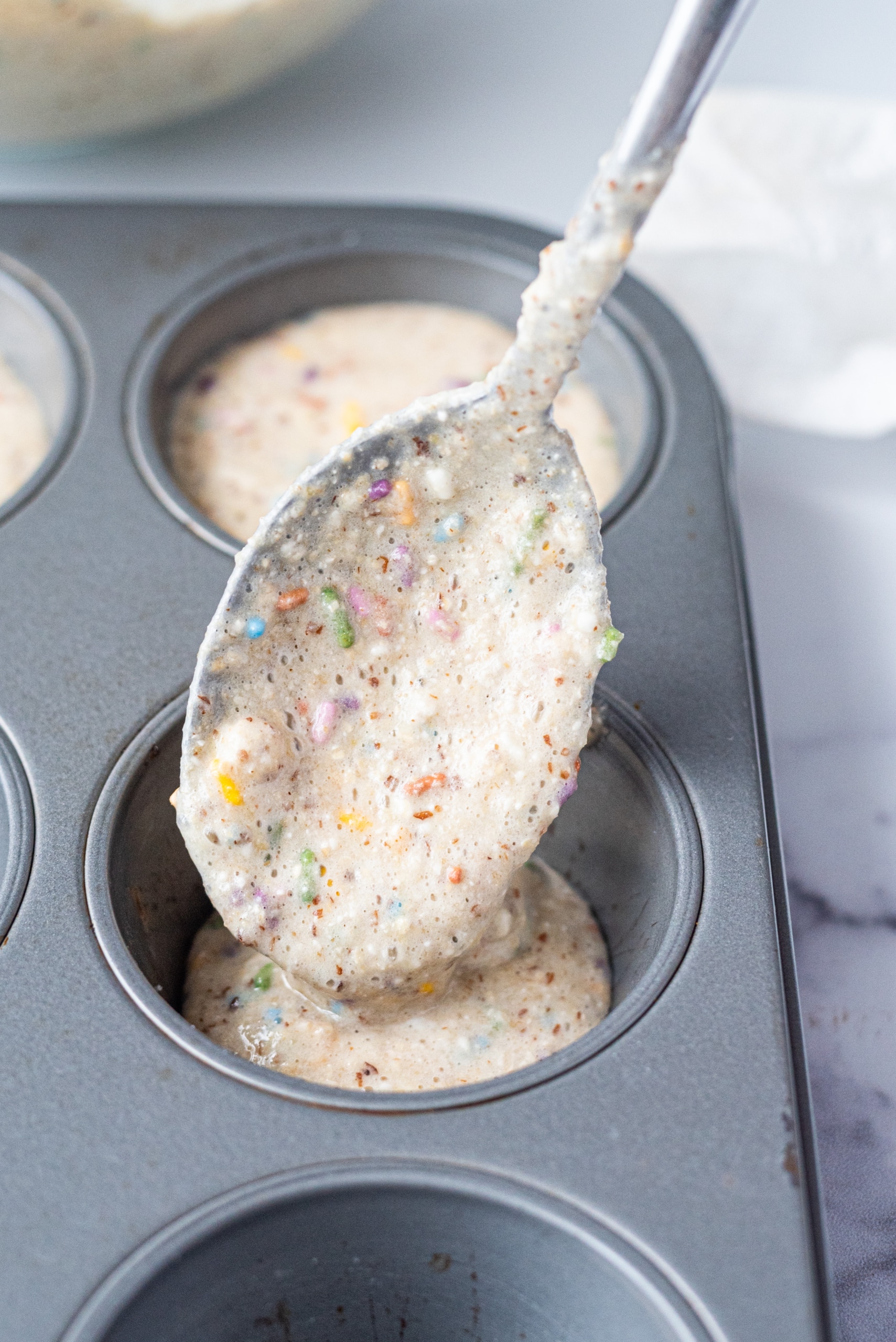 A muffin tin filled with cupcake batter.