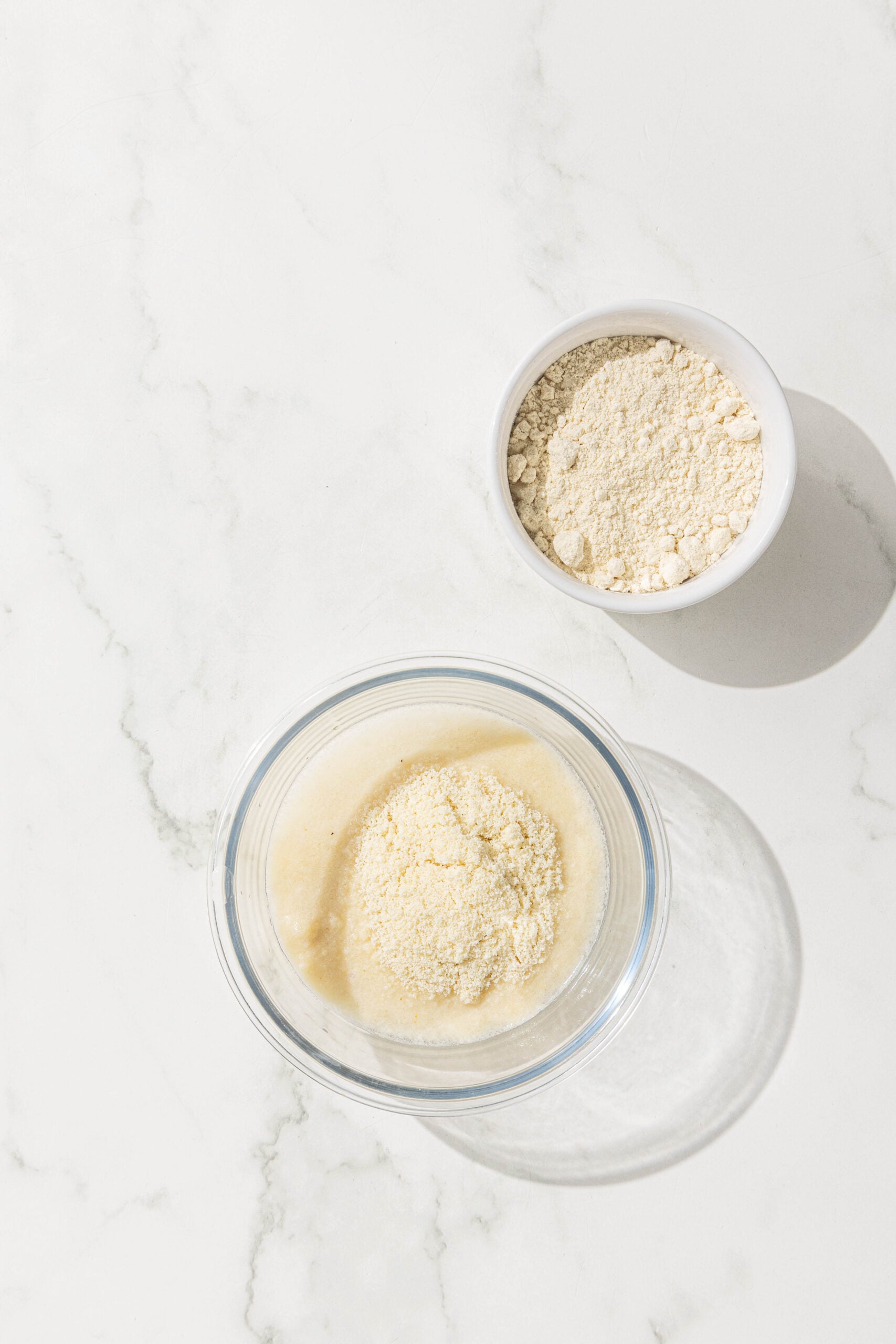 Two bowls of almond flour and chickpea flour.