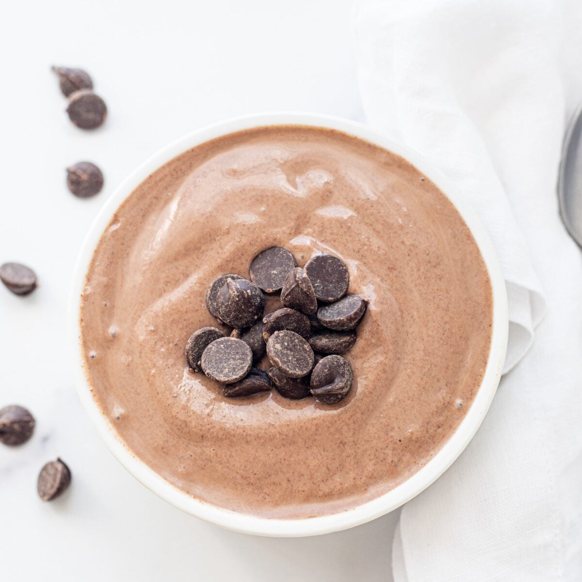 A bowl of tofu chocolate mousse topped with chocolate chips.