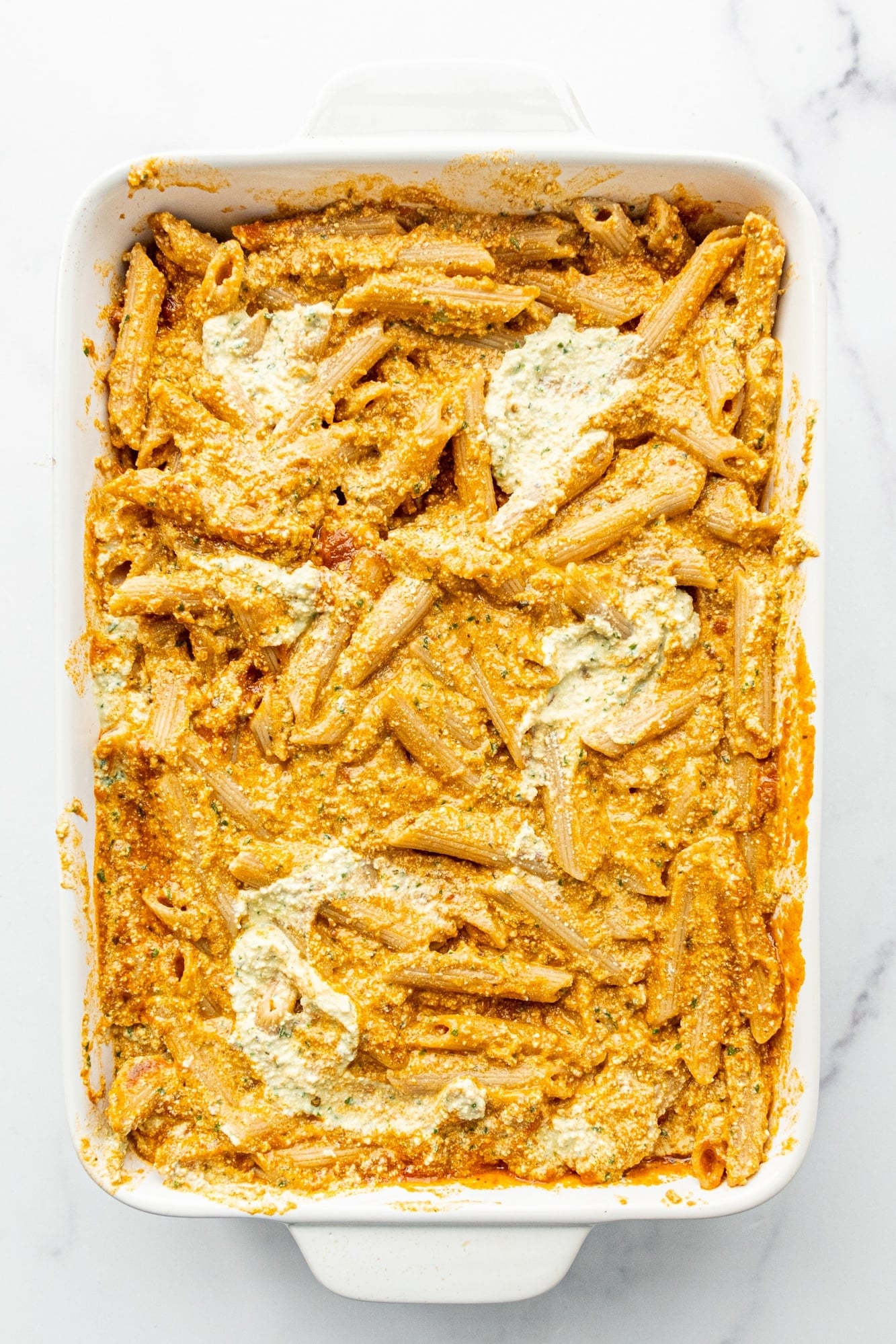 A 9x13 casserole dish of dairy-free baked ricotta pasta.