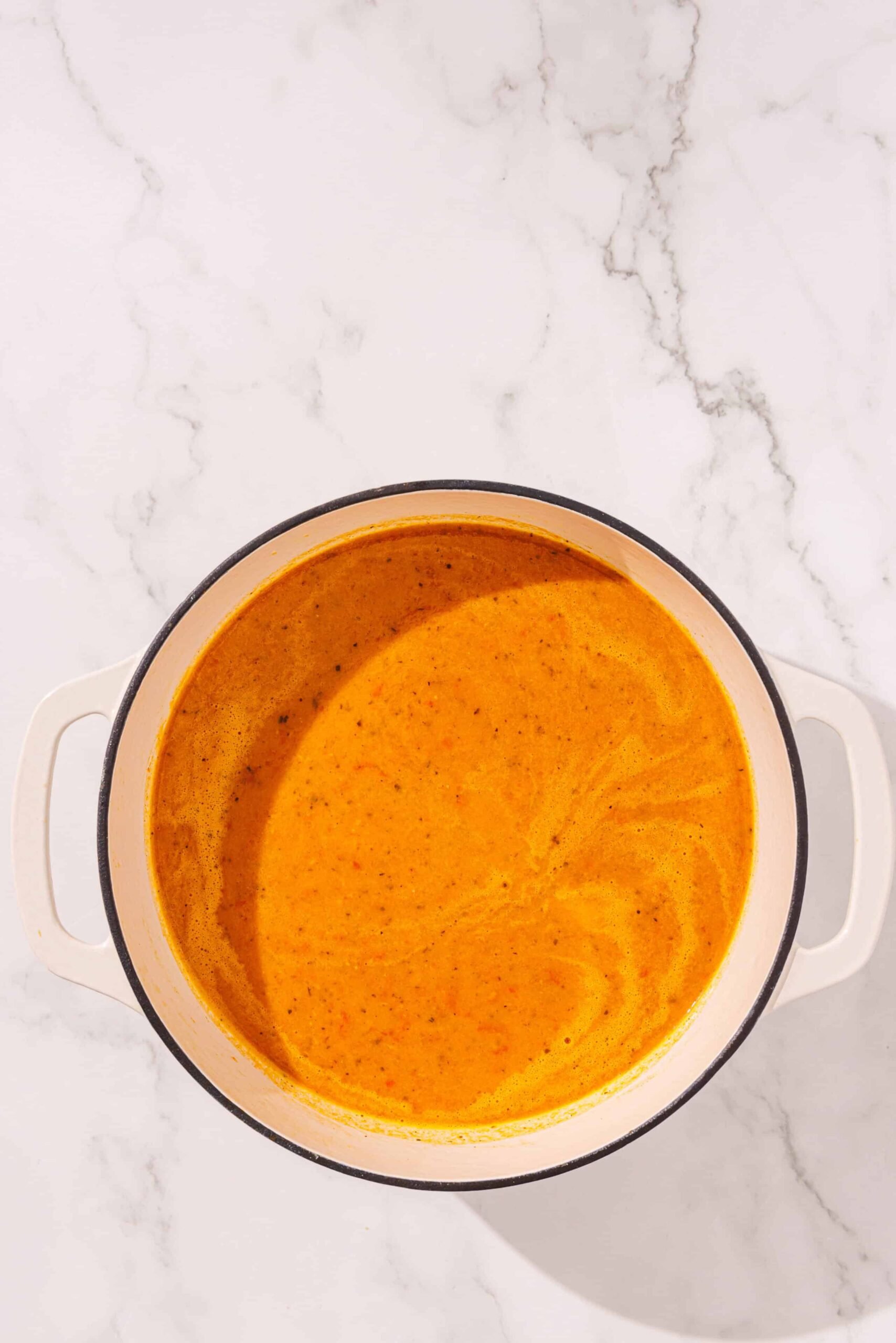 A white ceramic bowl filled with glowing skin soup.