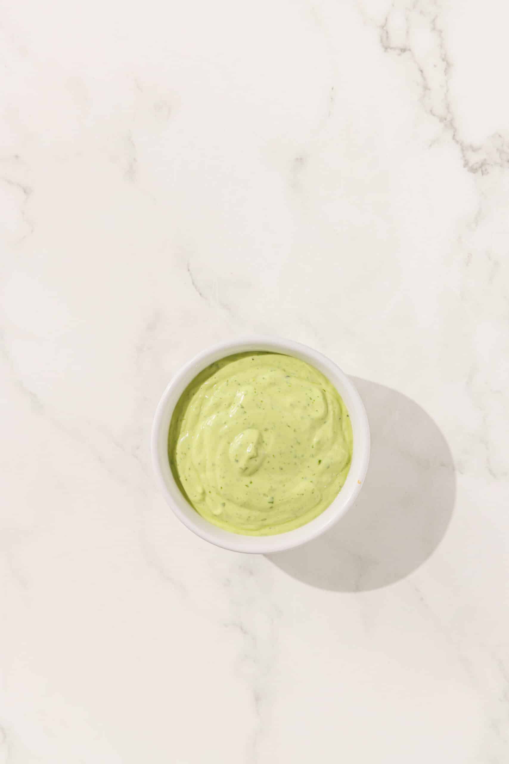 A white bowl of avocado crema.
