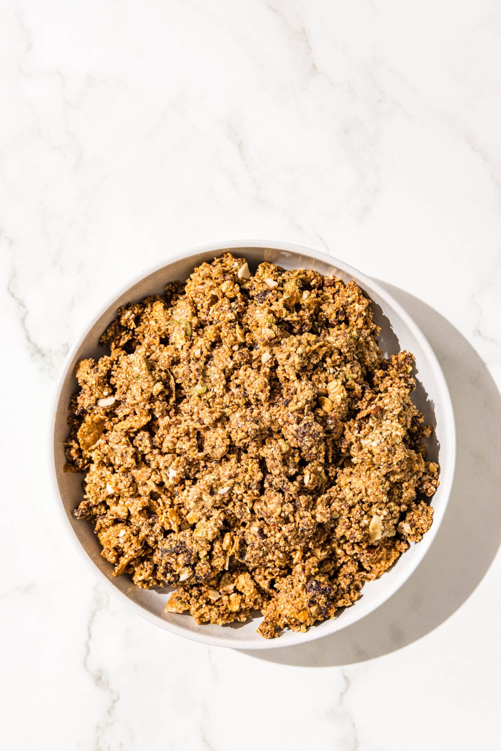 A white bowl filled with blended cereal bar dough.