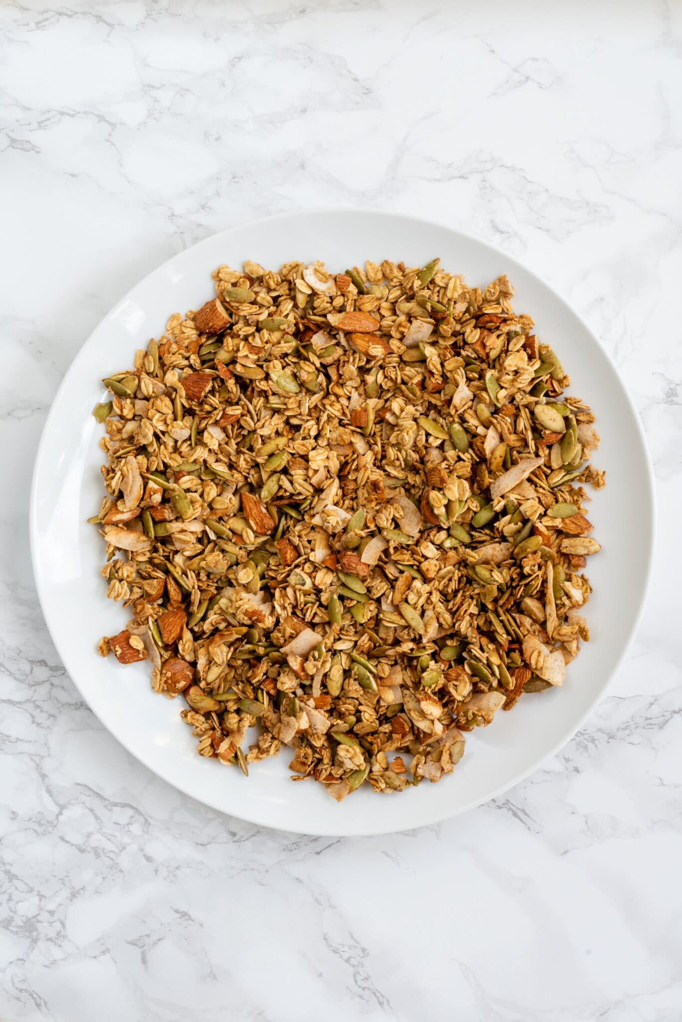A white plate filled with pumpkin spice granola.
