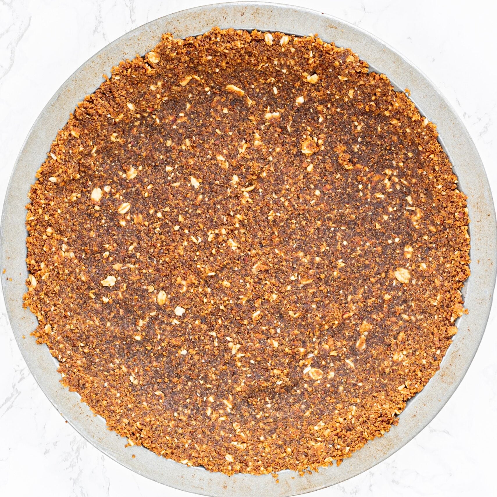 A pie pan filled with pie crust.