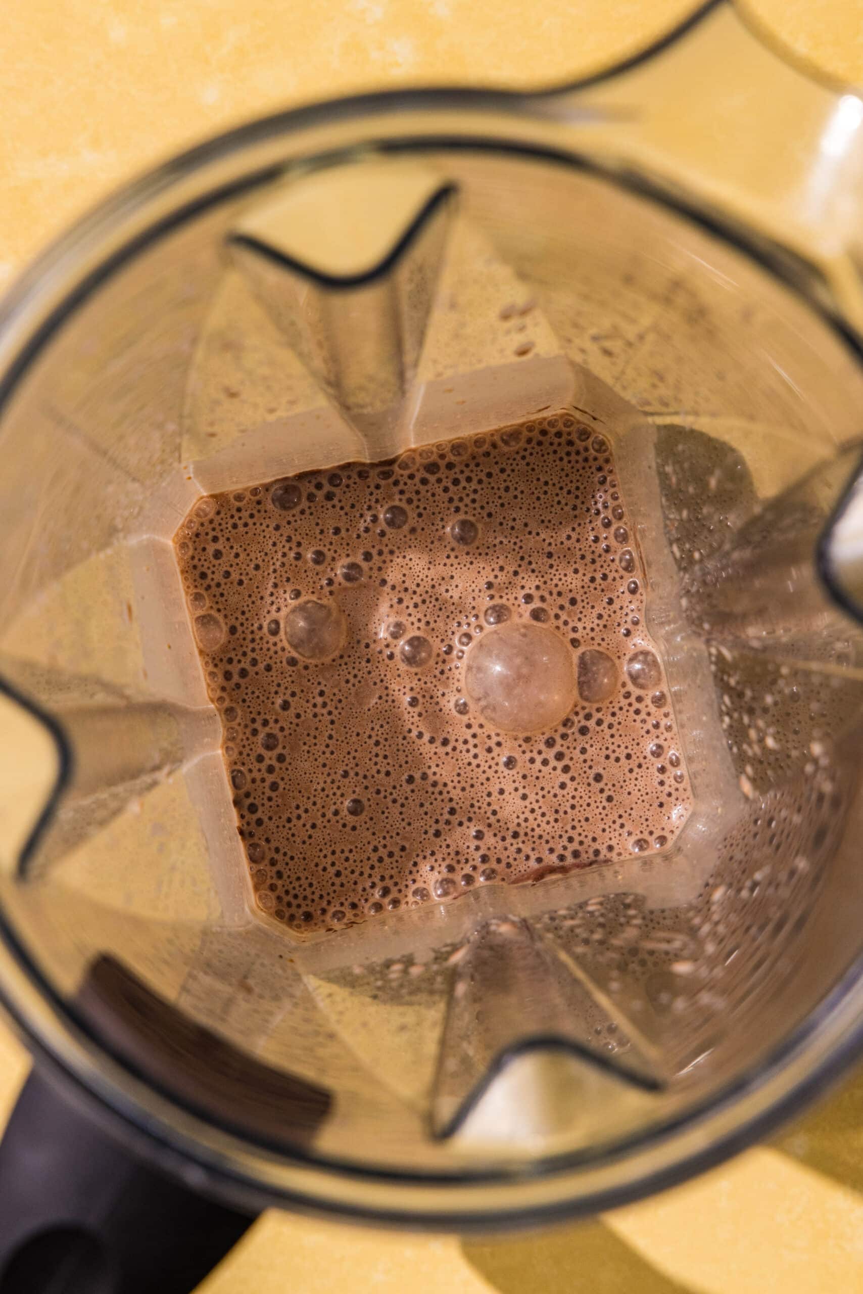 A blender filled with brown liquid.