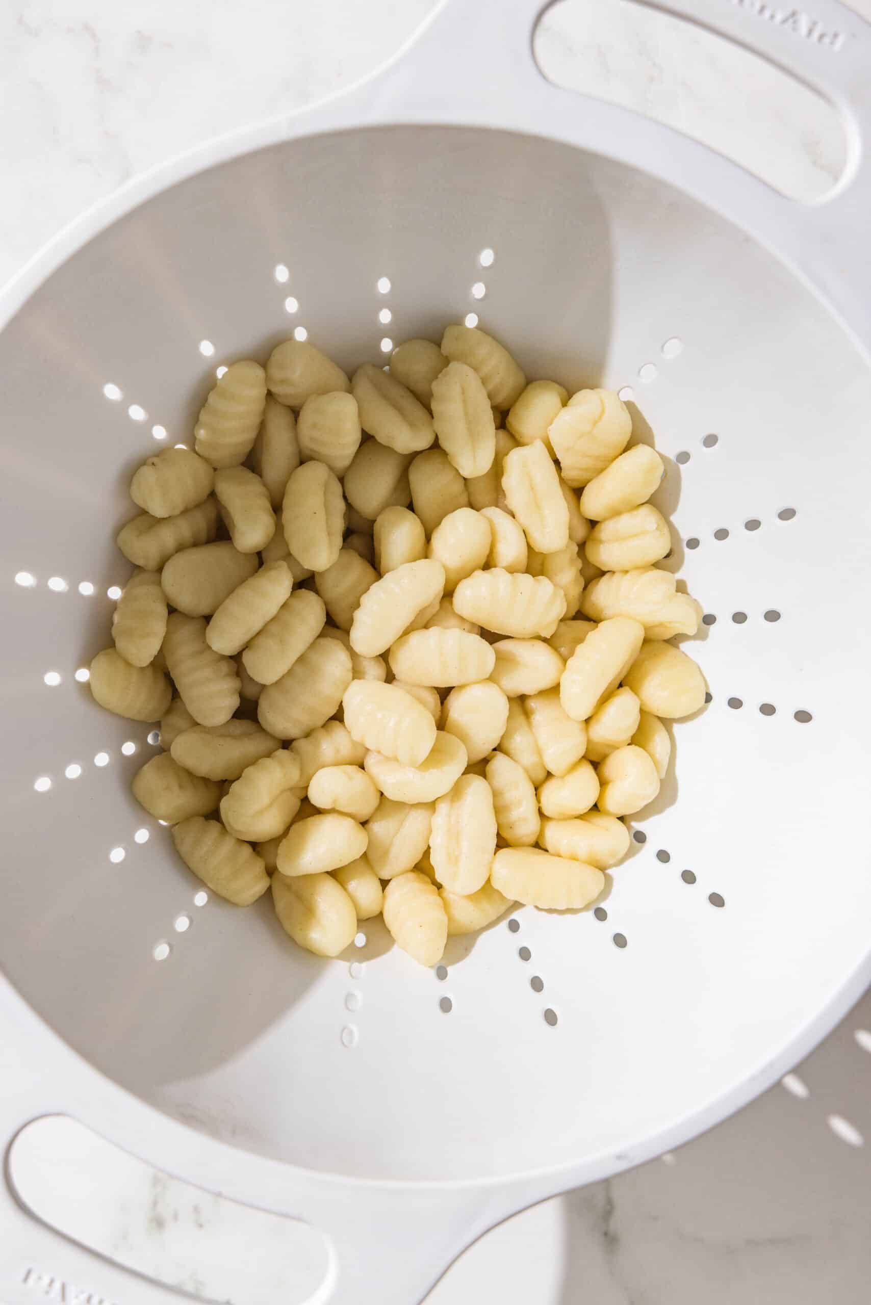 A colander filled with gnocchi.