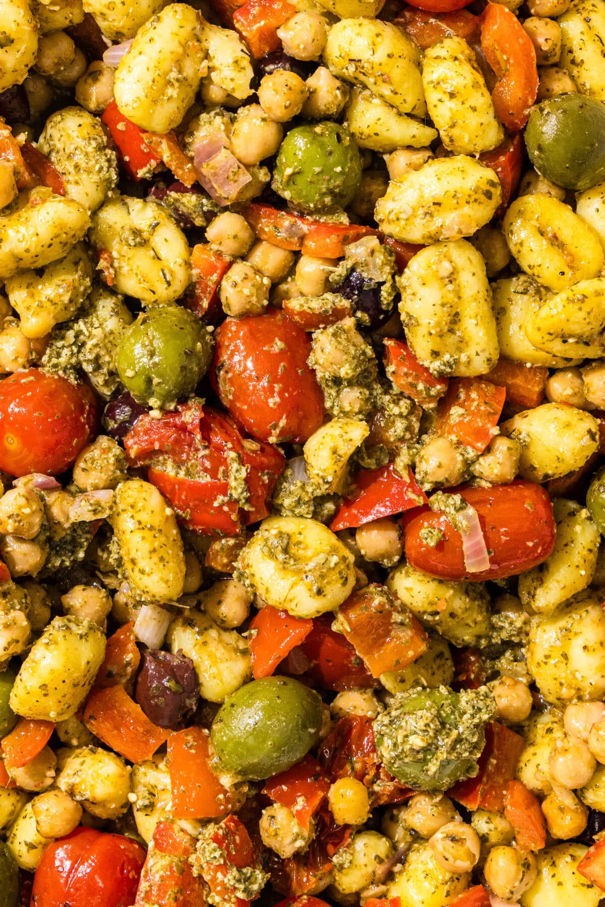 Mediterrnaean pesto gnocchi with olives, tomatoes, chickpeas, and gnocchi.