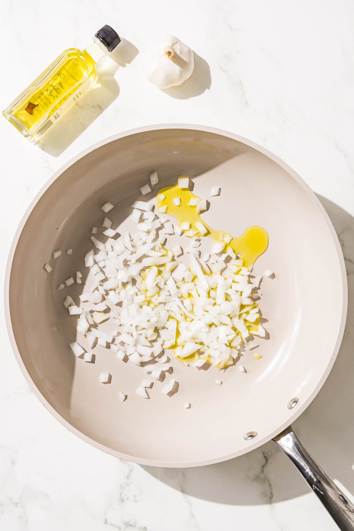 A pan filled with diced onion and olive oil.