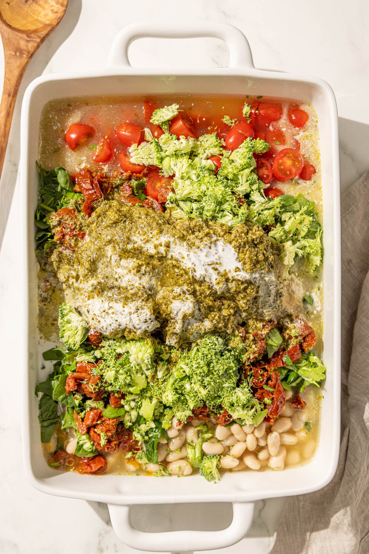 A 9x13 casserole dish of pesto quinoa bake.