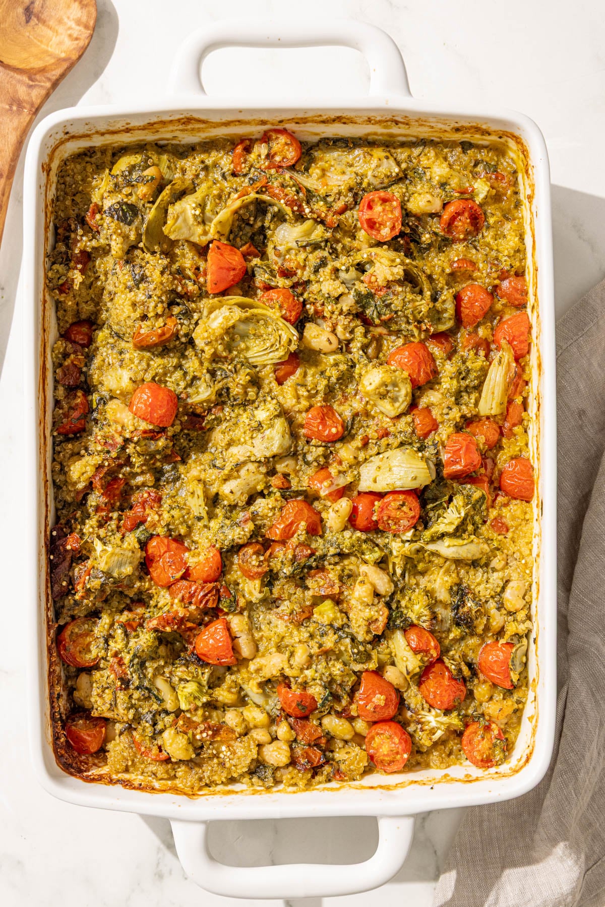 A 9x13 casserole dish of pesto quinoa bake.